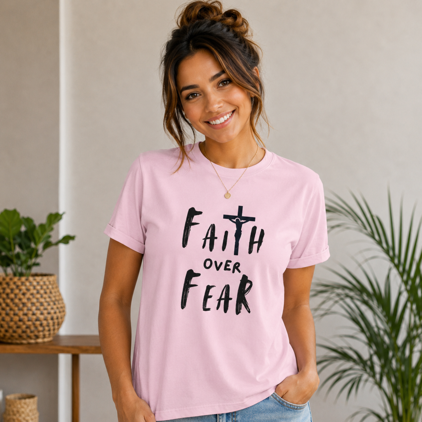 Light pink Christian T-shirt with black cross and 'Faith over Fear' front graphic text