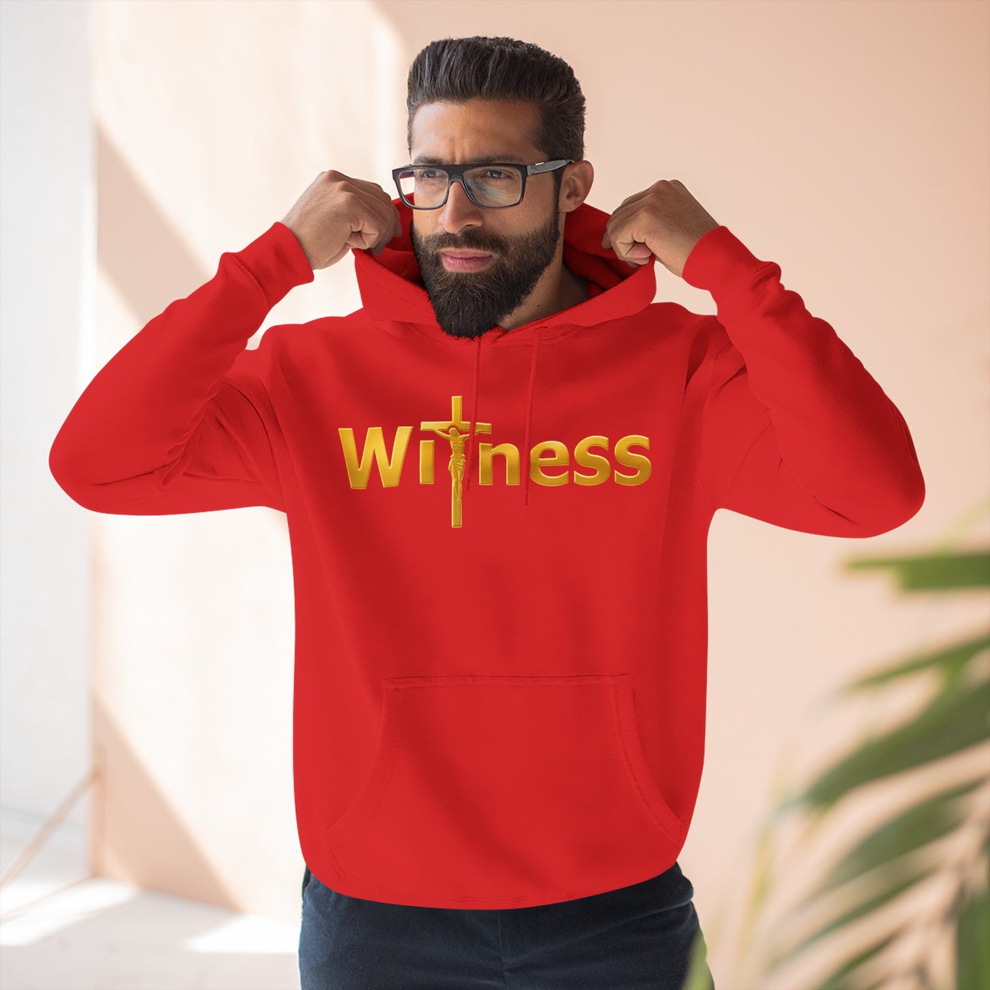 Red pullover hoodie with gold “Witness” print and cross emblem, hood with front pocket.