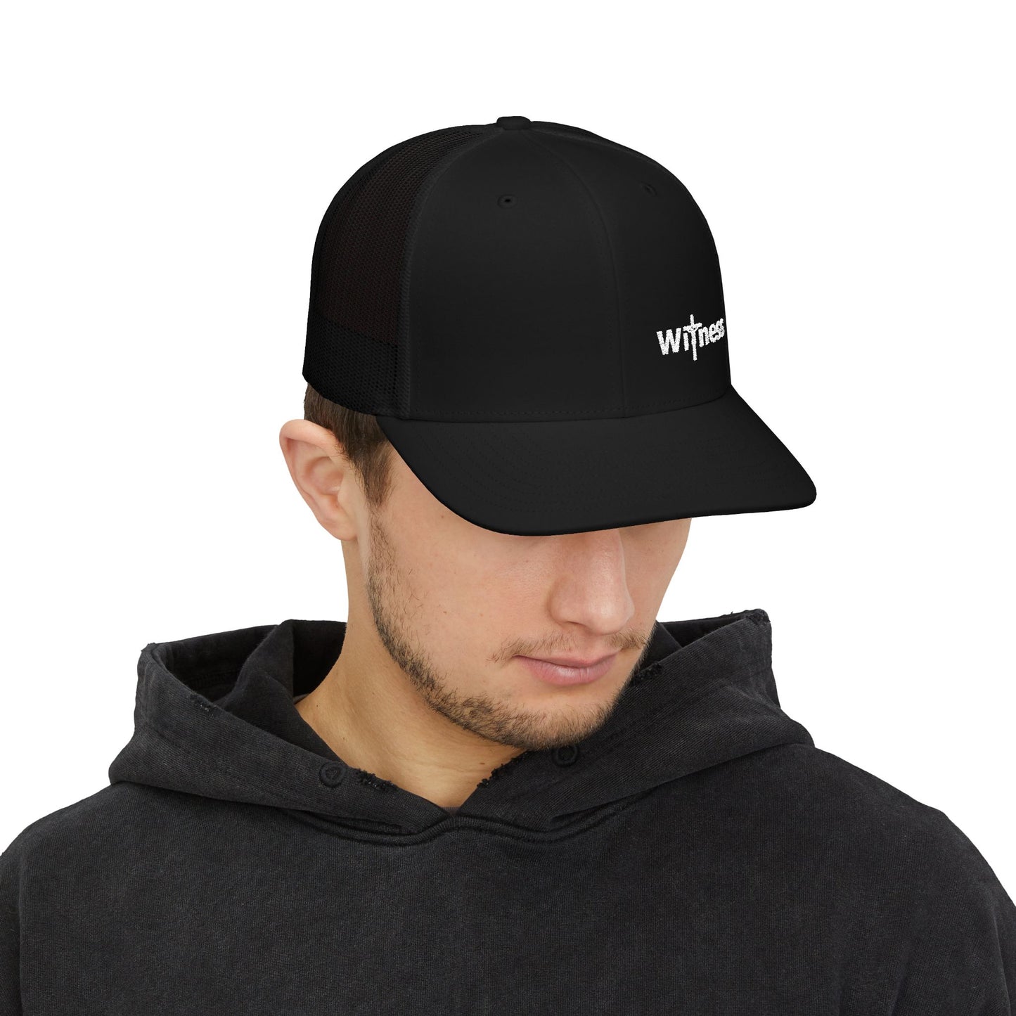 Black trucker hat with short brim and embroidered “Witness” logo, worn