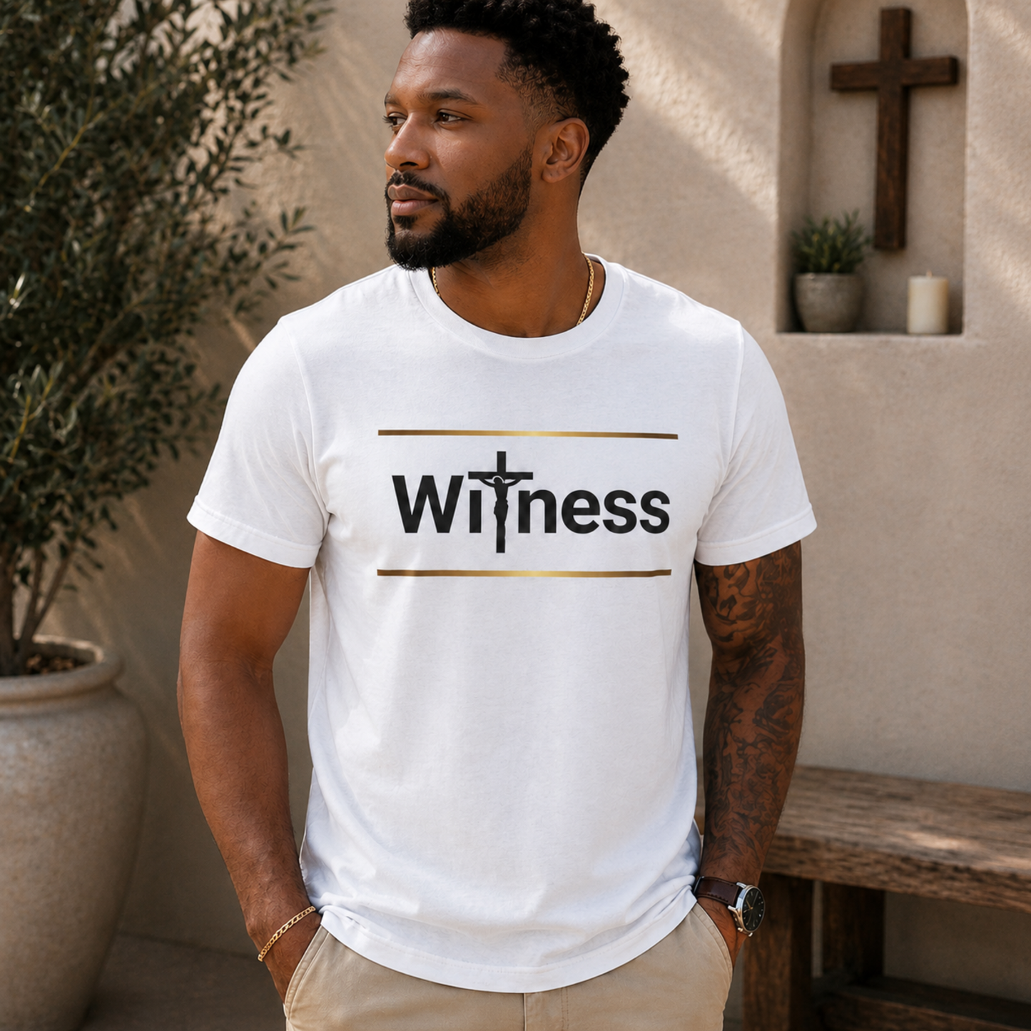 White T-shirt showing gold stripes and Witness cross emblem on front