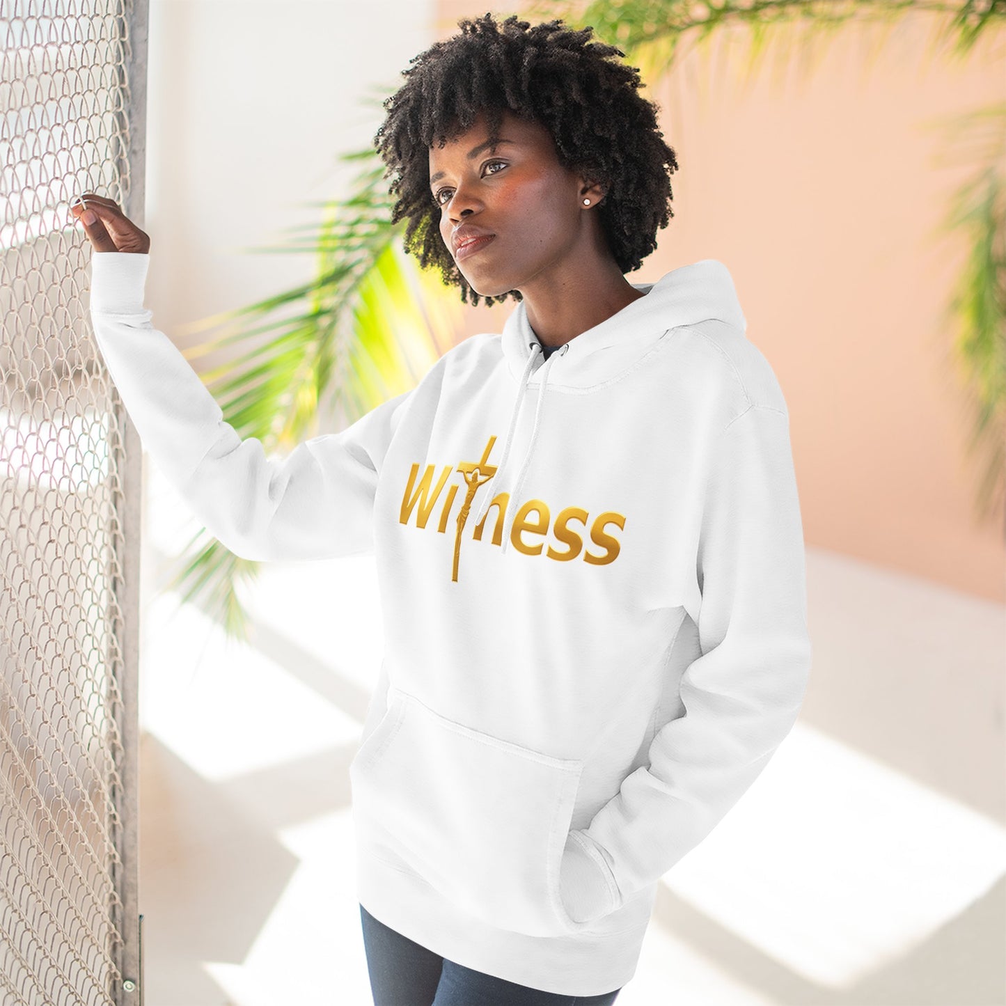 White pullover hoodie with gold “Witness” print and cross emblem, hood and front kangaroo pocket.