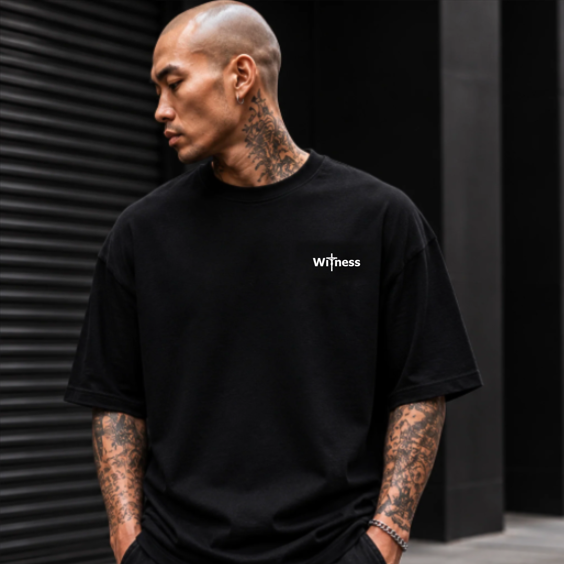 Black crewneck graphic T-shirt with 'witness' logo on chest