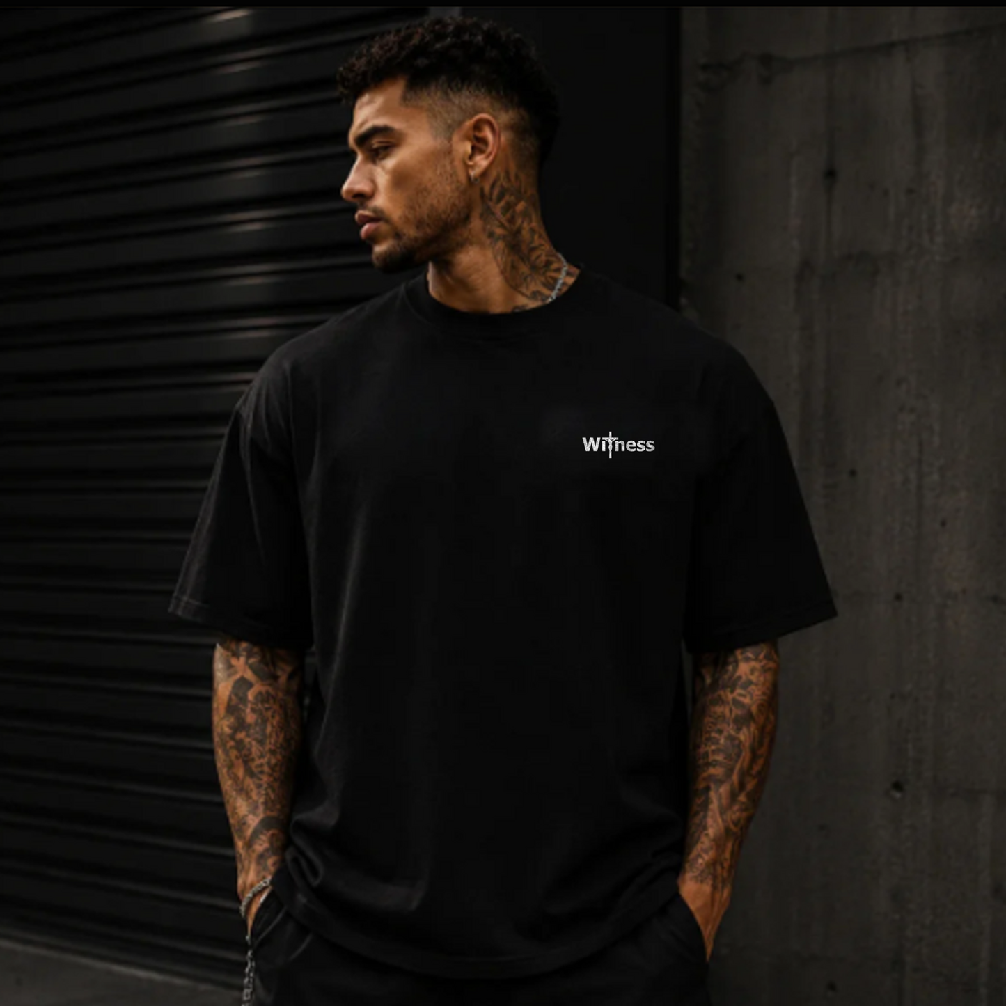 Black T-shirt with small front 'Witness' text graphic